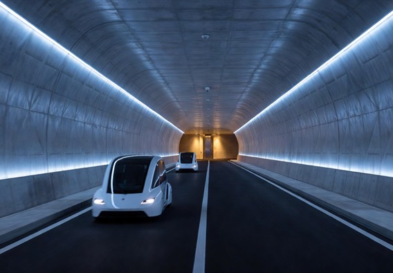 Photorealistic wide-angle view inside a completed smart underground tunnel glowing with cool blue and white LED lighting strips along both walls, two sleek white electric autonomous vehicles moving in opposite lanes, polished concrete walls with subtle geometric patterning, a visible distant station turnaround with elevator shaft illuminated in warm amber light, sense of speed and technological precision, cinematic depth of field, futuristic but grounded